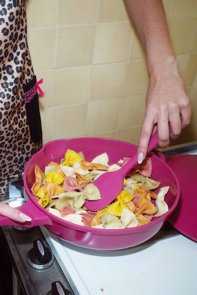 Sydney Carlson wearing Lynnee Kitchen Apron Leopard, Hot Pink and Black with Girly Lace and Ruffles, using 11" Hot Pink Frying Pan cooking Pasta, with Spatula