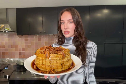 A warm stack of homemade pumpkin spice waffles topped with toasted pecan syrup, prepared using Lynnee non-stick cookware by Sydney Carlson.
