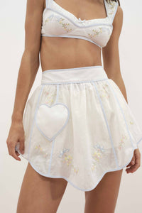 For Love & Lemons x Lynnee Collab, Model wearing Baby Bows apron with floral and bow details, heart pocket in front