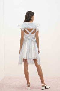 For Love & Lemons x Lynnee Collab Model wearing Bluebell Gingham Apron with flowers and bows, ties in a bow in the back, back view