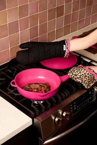 Lynnee Oven Mitt and Pot Holder Set, Leopard, Hot Pink and Black with Girly Ruffles and hanging loop cooking yummy steak in 11" Hot Pink Frying Pan in the kitchen